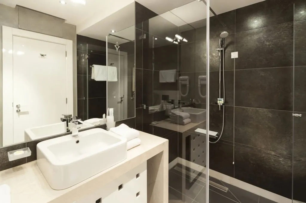 Glass mirror and thin framed shower screen